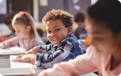 student-smiling-in-classroom-rounded